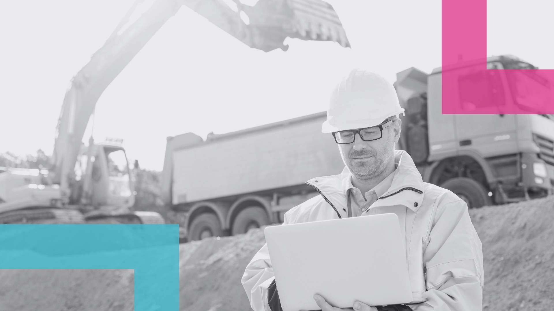 Man in PPE holding a file of documents on a worksite standing in front of a truck and an excavator