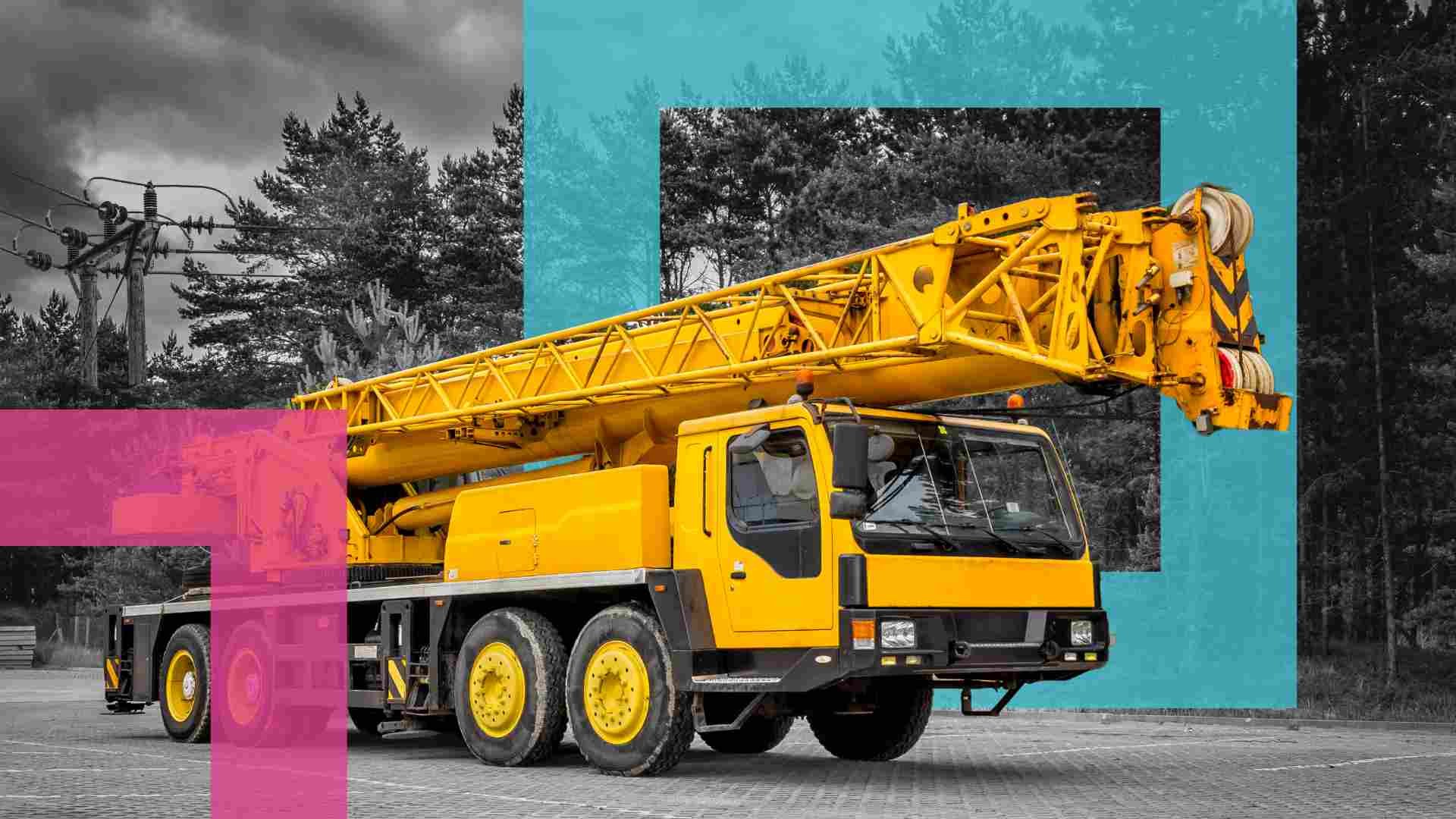 yellow mobile crane parked on the road