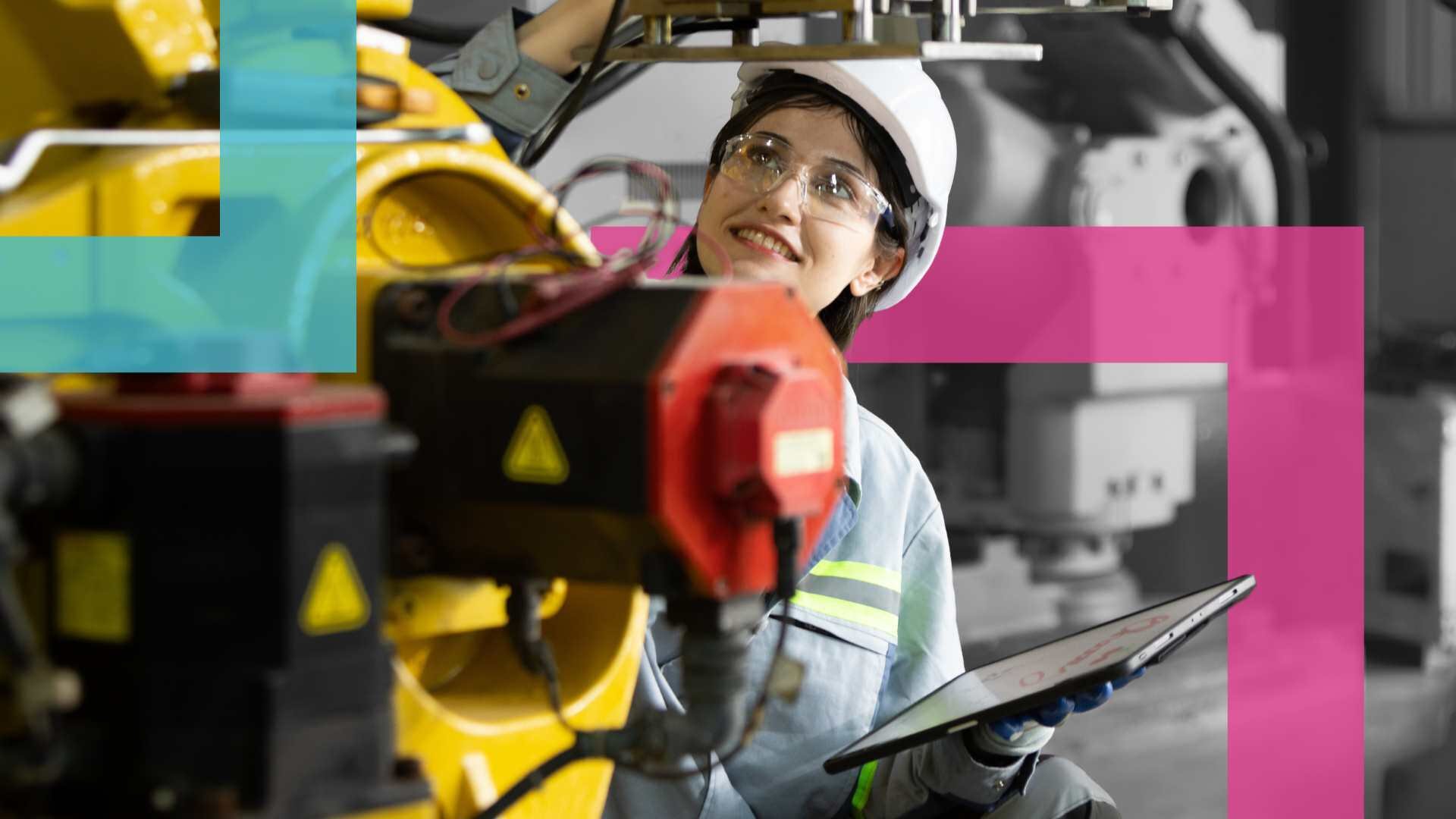 Woman wearing PPE inspecting a machine