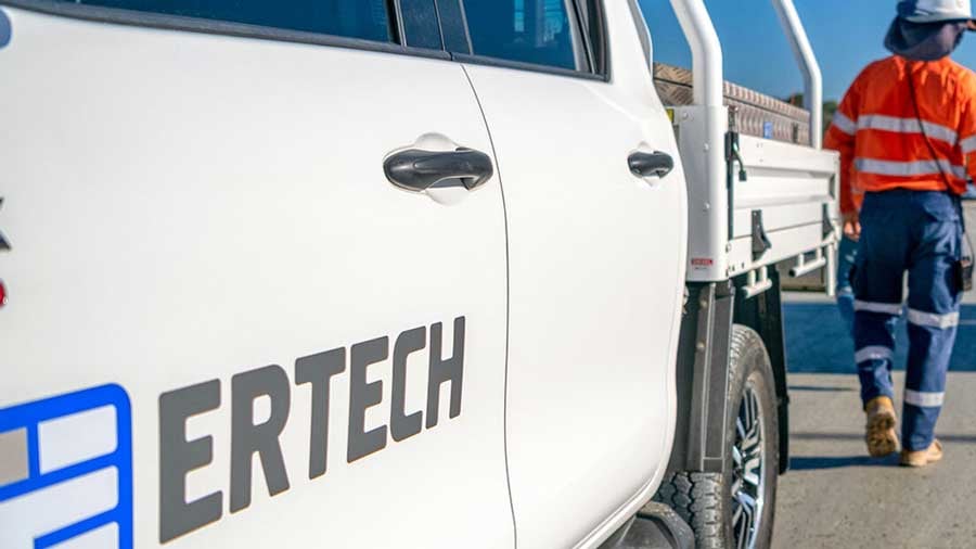 Ertech logo on white ute with tradesman in background