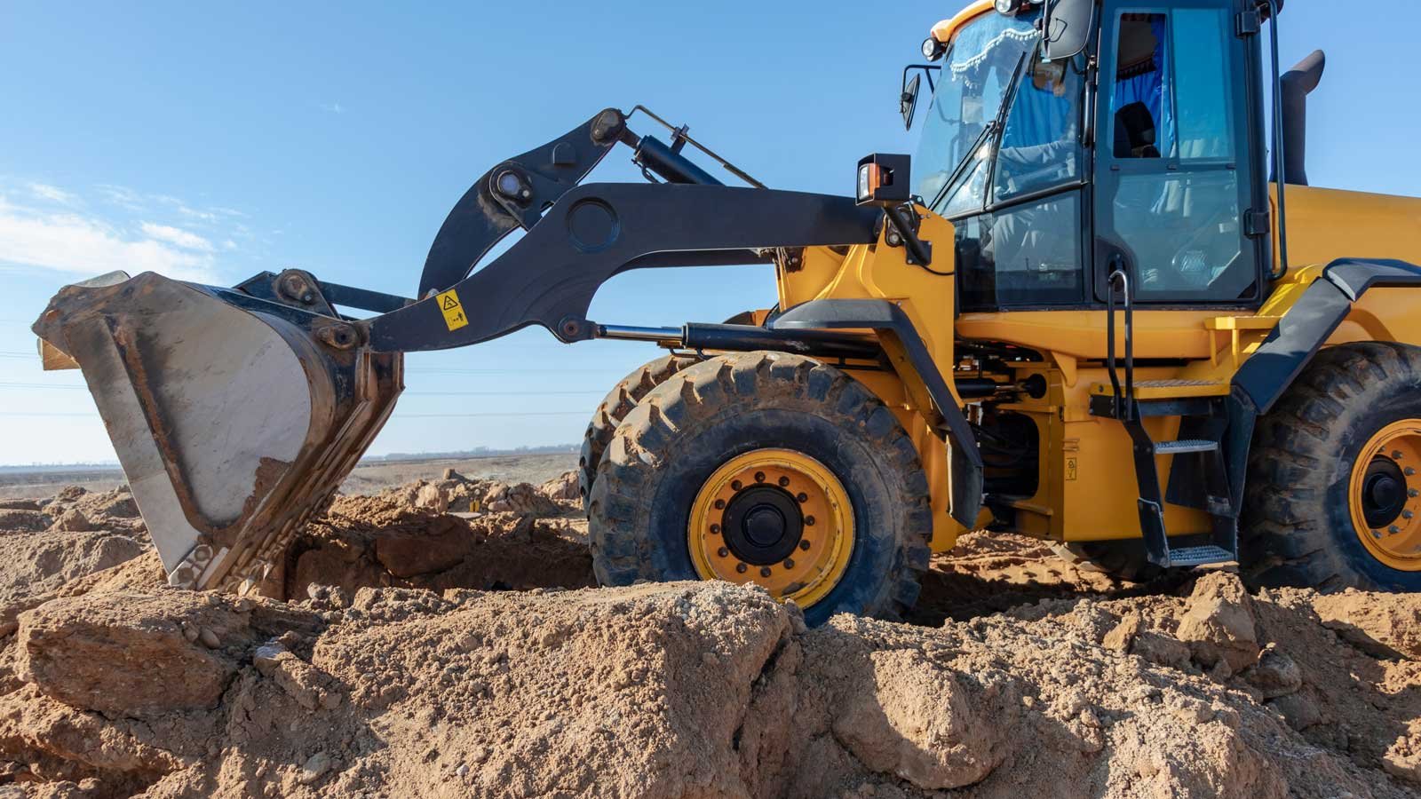 Excavator moving dirt