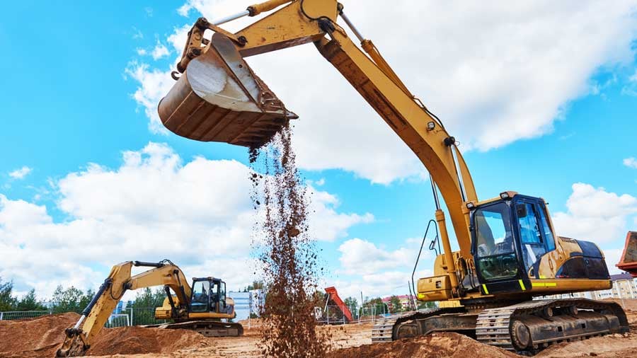 Two excavators moving dirt on a work site