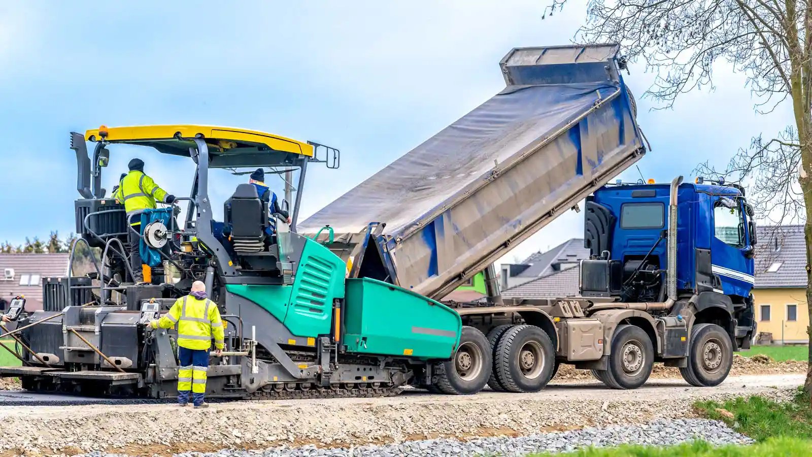Truck unloading asphalt onto a new road