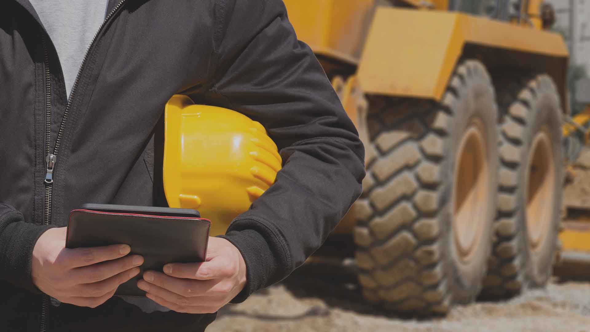 man conducting risk assessment on heavy machinery