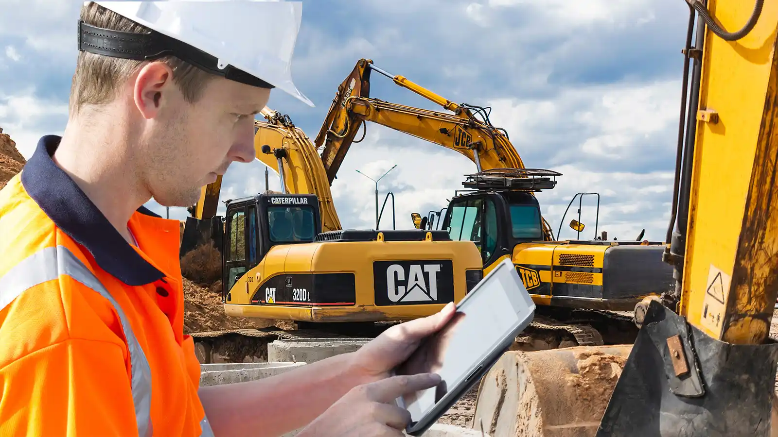 Construction-worker-reading-paper-on-clipboard-standing-in-front-of-yellow-heavy-machinery