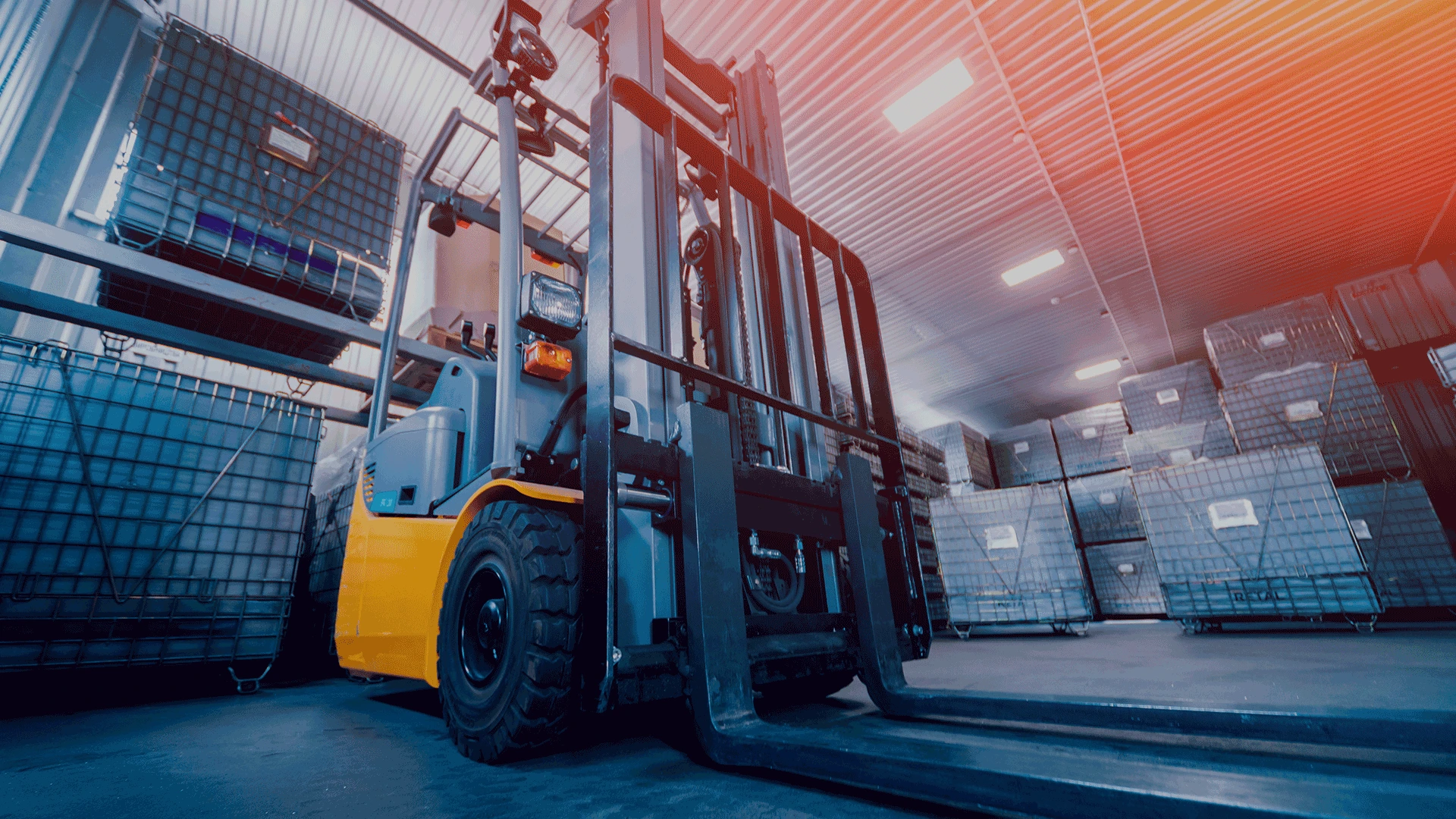 Close up of a yellow forklift in a warehouse environment