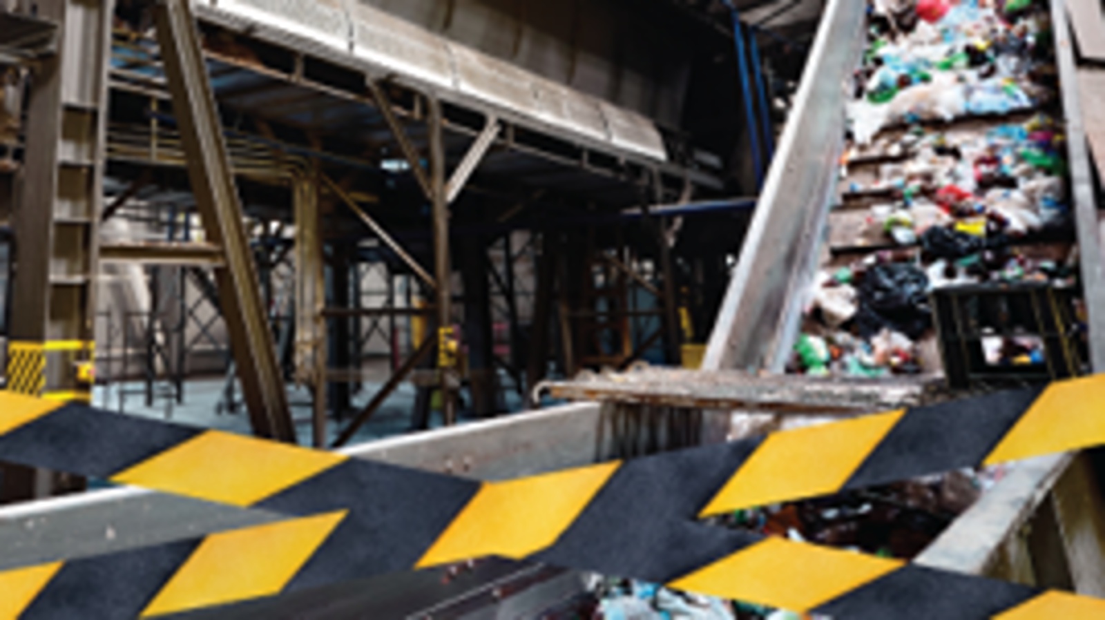 recycling plant with black and yellow tape at the forefront