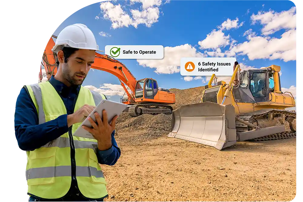 Man in safety PPE on an ipad overseeing a construction work site with bulldozer and excavator