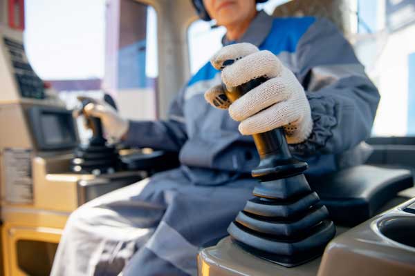 Man in safety PPE operating machine